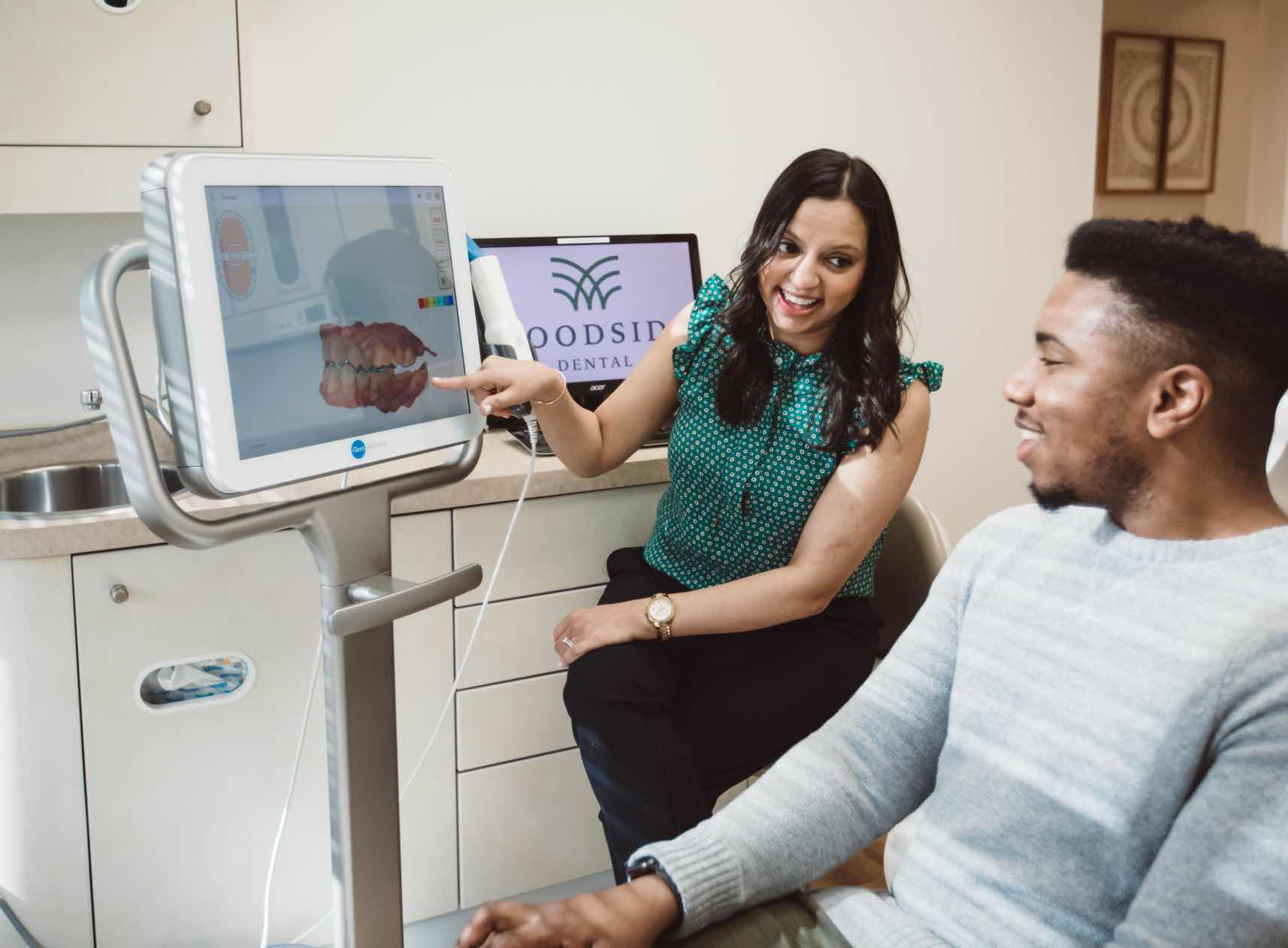 Photo of Columbia Maryland dentist Dr. Shah showing a 3-D dental scan to a patient