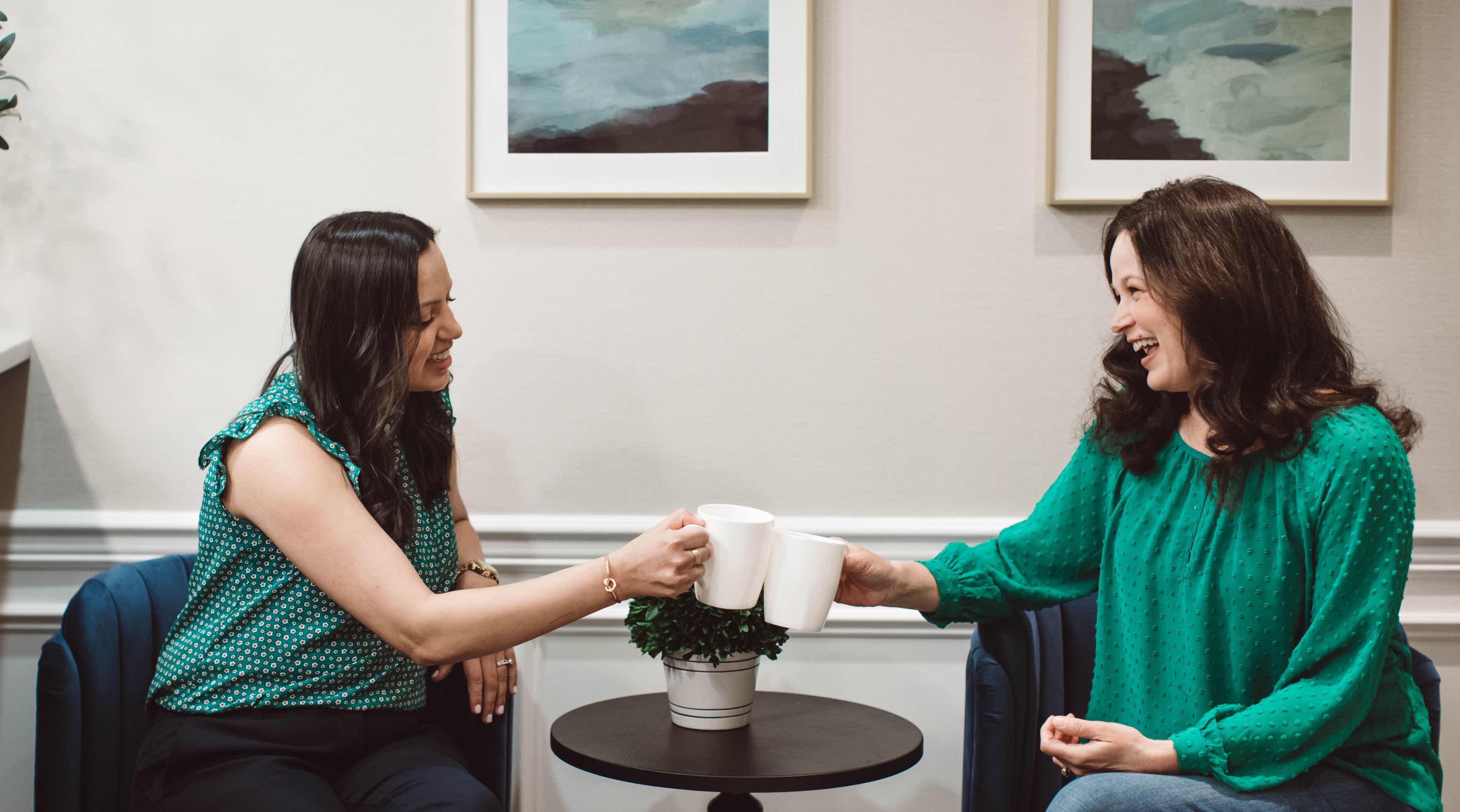 Photo of Dr. Shah with a patient drinking coffee
