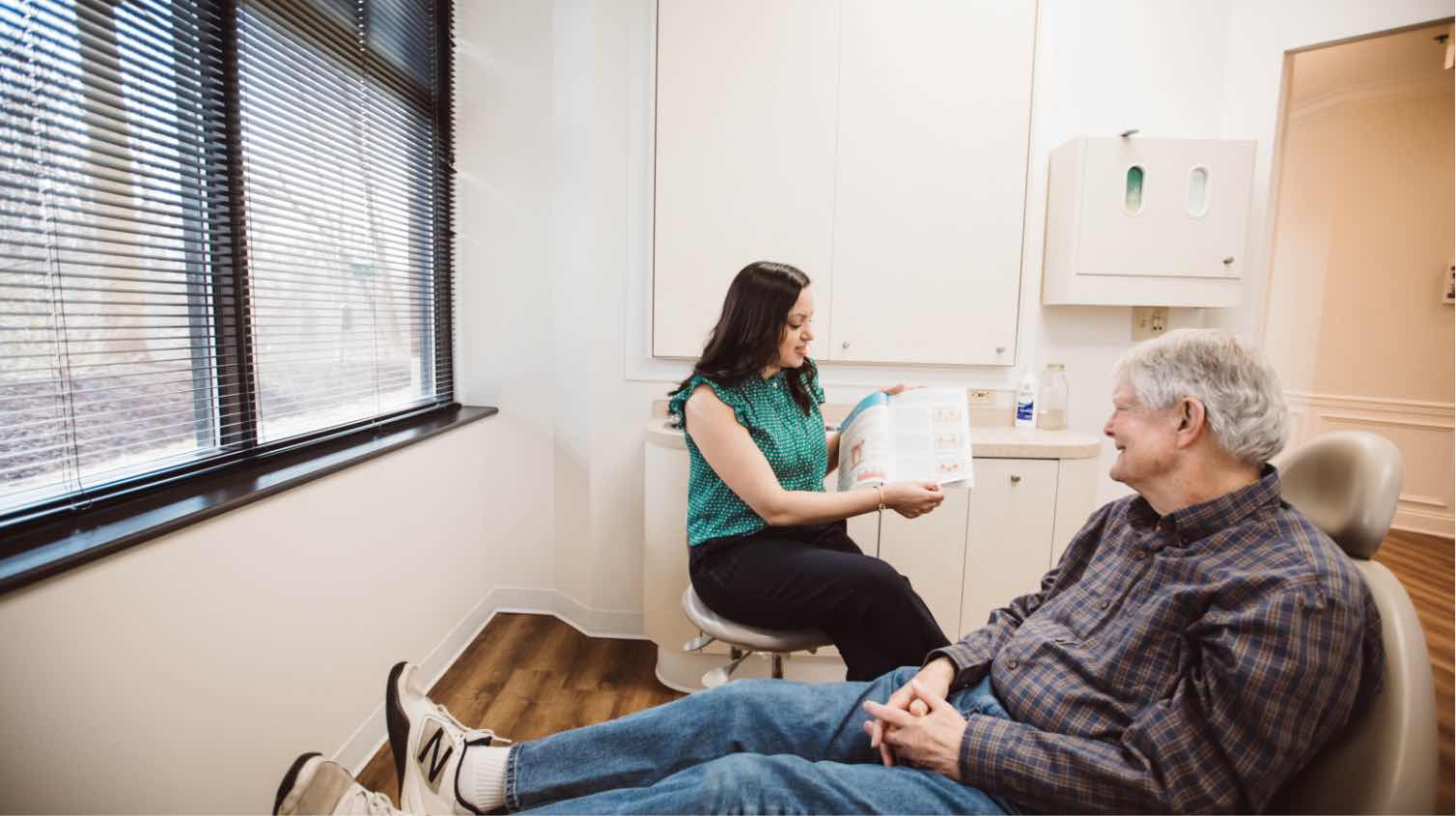 Photo of Dr. Shah reviewing treatment plans with a patient