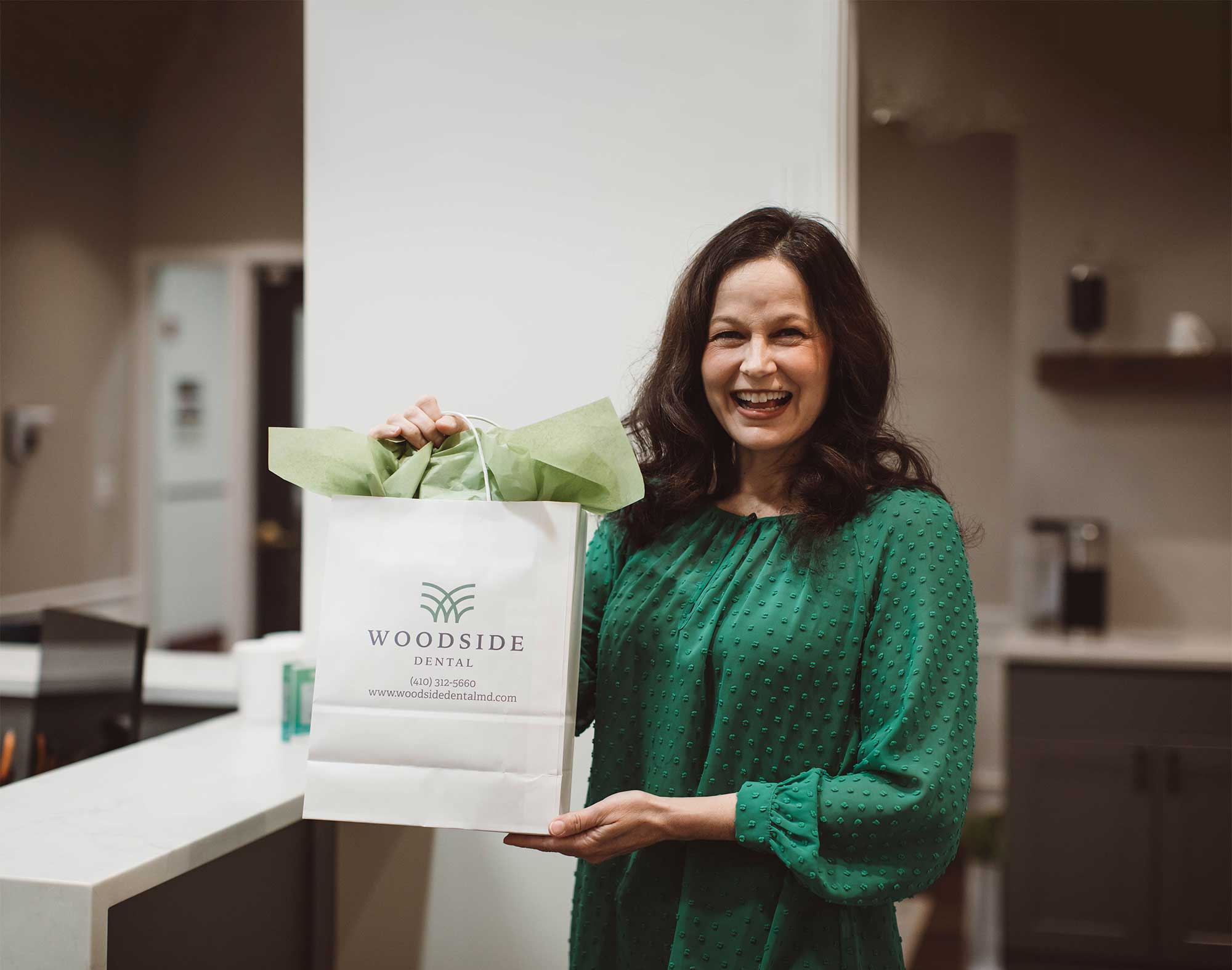 Photo of a patient holding a gift bag from the Woodside team